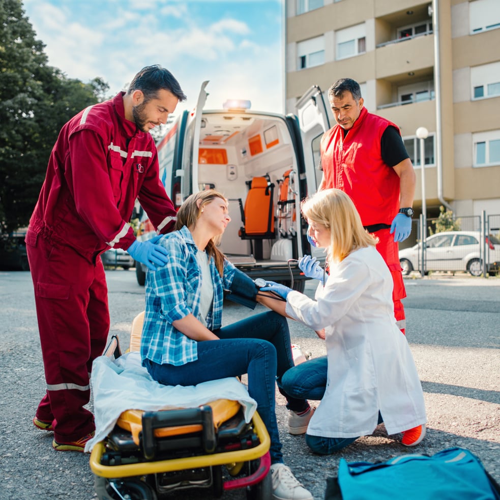 Medical emergency team helping injured woman